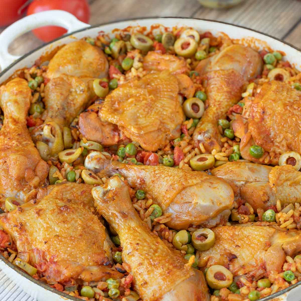 Closer vsiew Arroz Con Pollo in a shallow Le Creuset baking dish