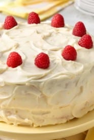 close up of Moist Banana Cake decorated with raspberries