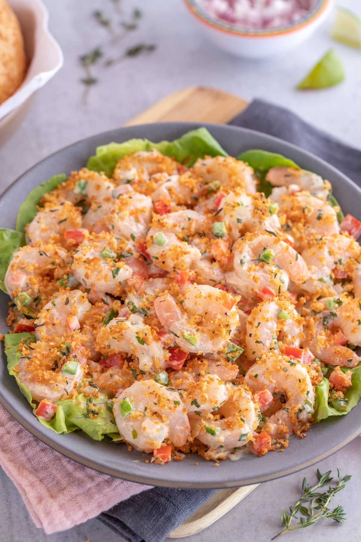 Dark blue plate holding Shrimp Salad with Lime Herb Dressing